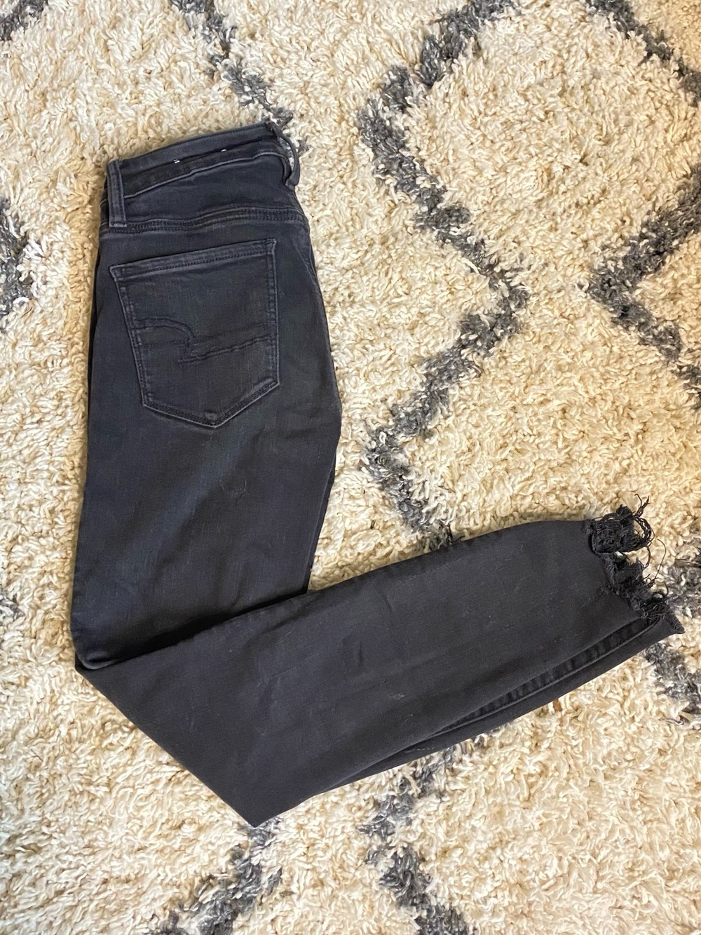 Black American Eagle Skinny Jeans with Raw Hem